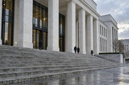 Synthetic editorial illustration. Unbranded civic building with stone columns and broad steps for regulation, courts and trade-policy news.