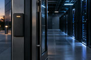 Synthetic editorial illustration. Unbranded access-control reader at the entrance to a dim data-centre corridor for cybersecurity and resilience news.