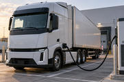 Synthetic editorial illustration. A cargo truck is connected by one continuous cable to a depot charging pedestal.
