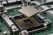 Synthetic editorial illustration. Metal tweezers hold a plain square processor package above an open socket lined with gold contacts. A green circuit board, metal fixture and fasteners sit beneath in shallow-focus inspection light.