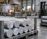 Synthetic editorial illustration. Generic aluminium casting workshop with pale silver metal billets and handling fixtures; no named producer, actual contract, exact alloy grade or purity claim.