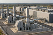 Synthetic editorial illustration. An industrial power campus. Turbine enclosures, broad intake ducts and tall metal exhaust stacks stand directly beside low windowless halls with rooftop cooling units.