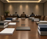 Synthetic editorial illustration. A windowless meeting room contains a long wooden table with blank binders, paper stacks and closed laptops. Three rear-facing advisers sit at the far end beneath warm ceiling lights.