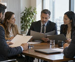 Synthetic editorial illustration. A quiet observational view into an ordinary corporate meeting room where representatives of two anonymous firms discuss a transaction, open folders seen from the blank back side; no posed handshake.