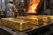 Synthetic editorial illustration. A working precious-metals refinery with several unmarked cast gold bars on a heat-resistant cooling bench and a distant worker seen from behind, tactile metal, restrained industrial light.