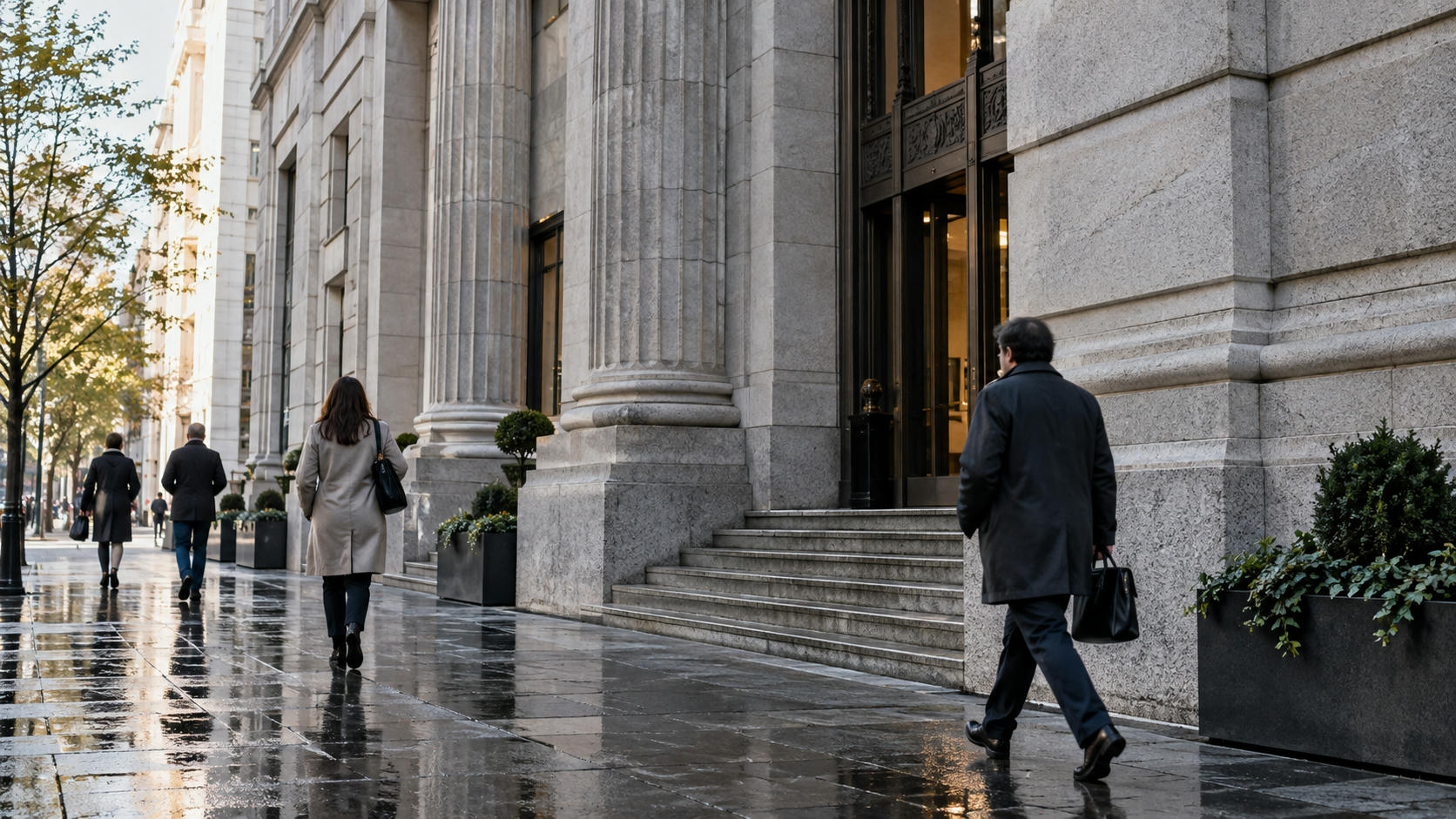 Synthetic editorial illustration. A sober anonymous institutional financial building at street level after rain, a few small pedestrians and real stone textures, balanced morning light, no flags, names or recognizable landmark.